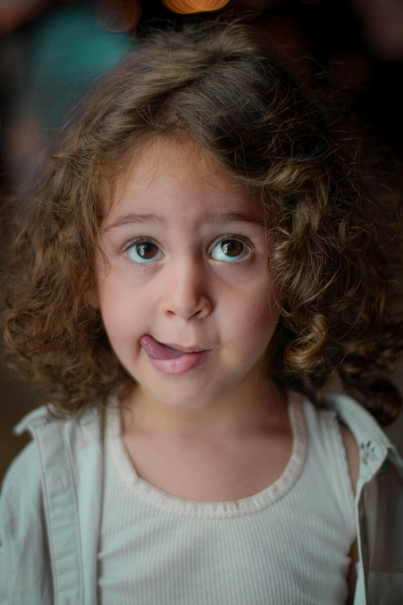 Little girl with her tongue out.