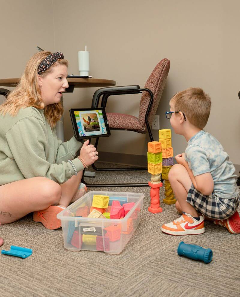 Boy playing with blocks with therapist