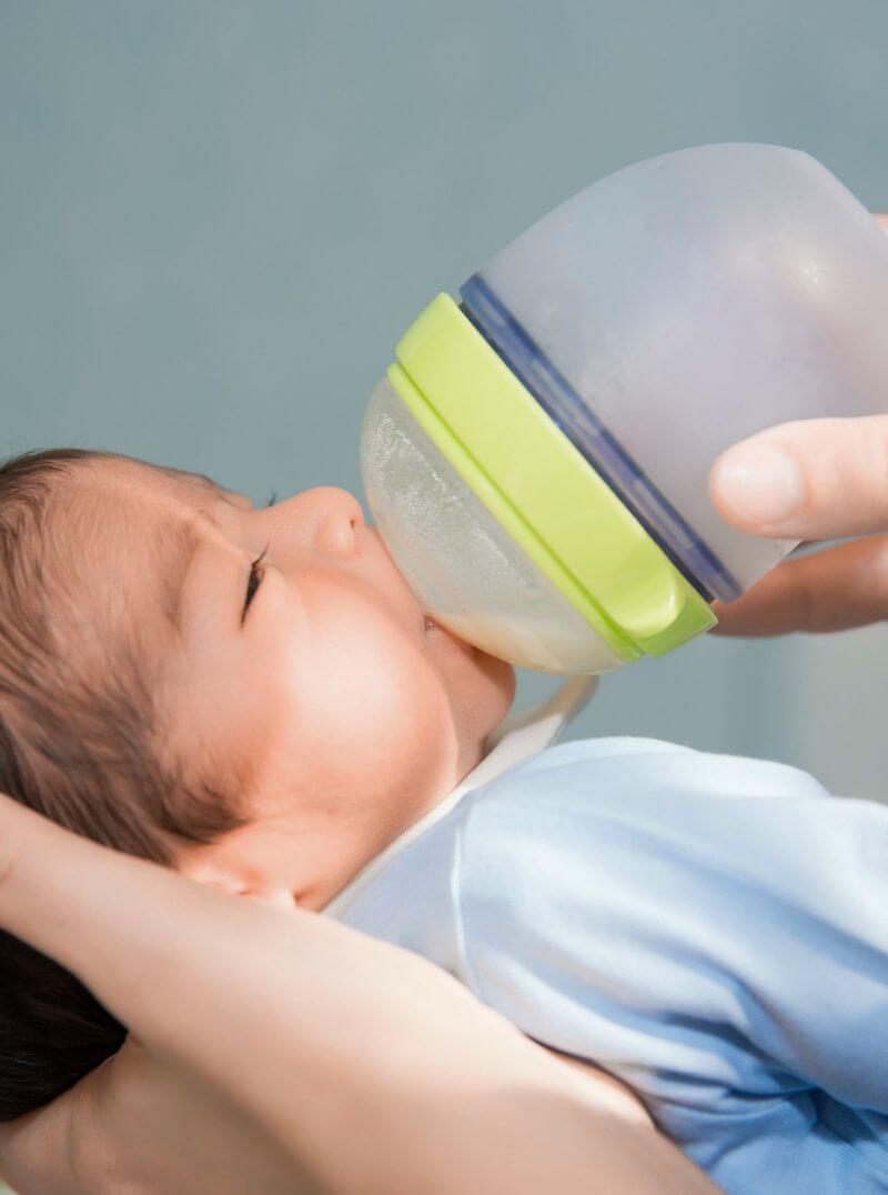 Newborn drinking from bottle.