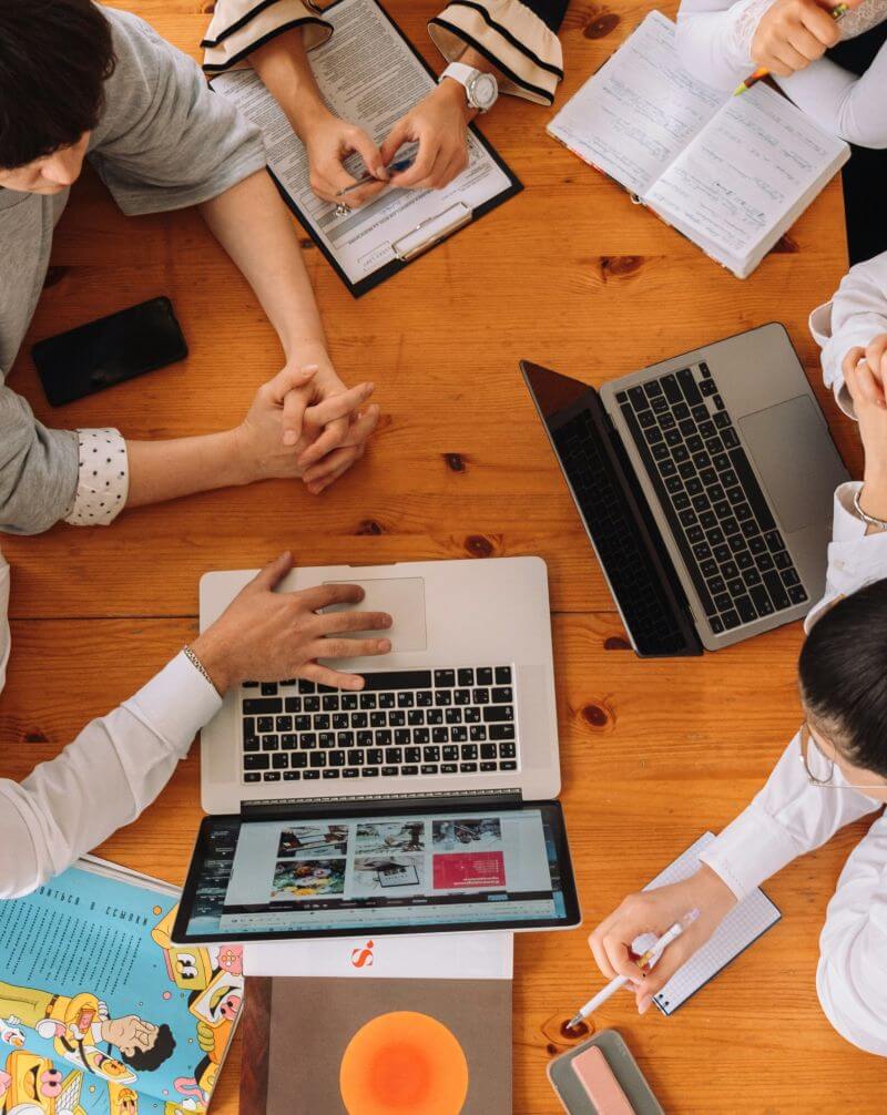 Group of people on laptops. Overhead view.
