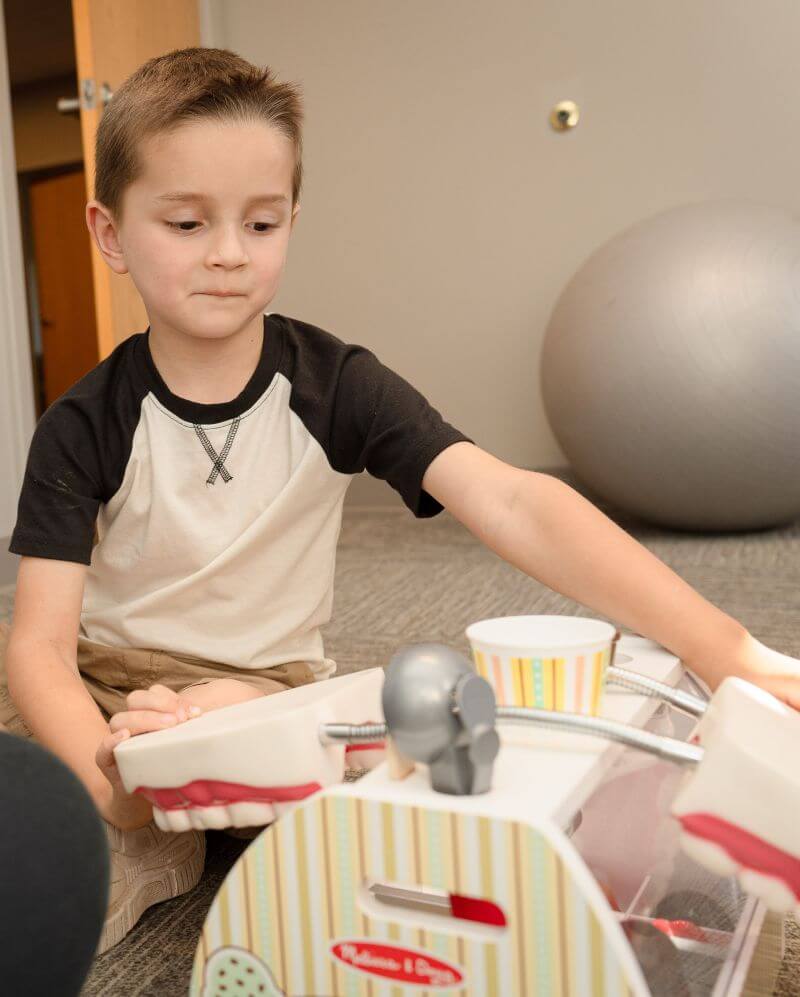 Boy playing with a toy.
